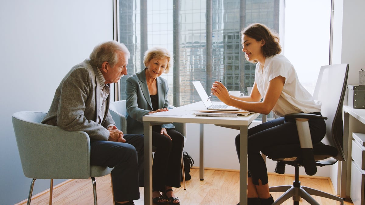 Senior couple meeting with their financial advisor in an office